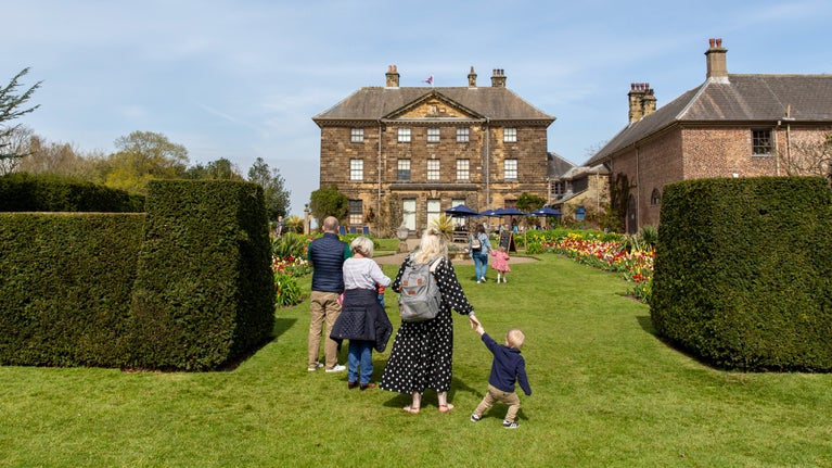 Family walking in garden in spring